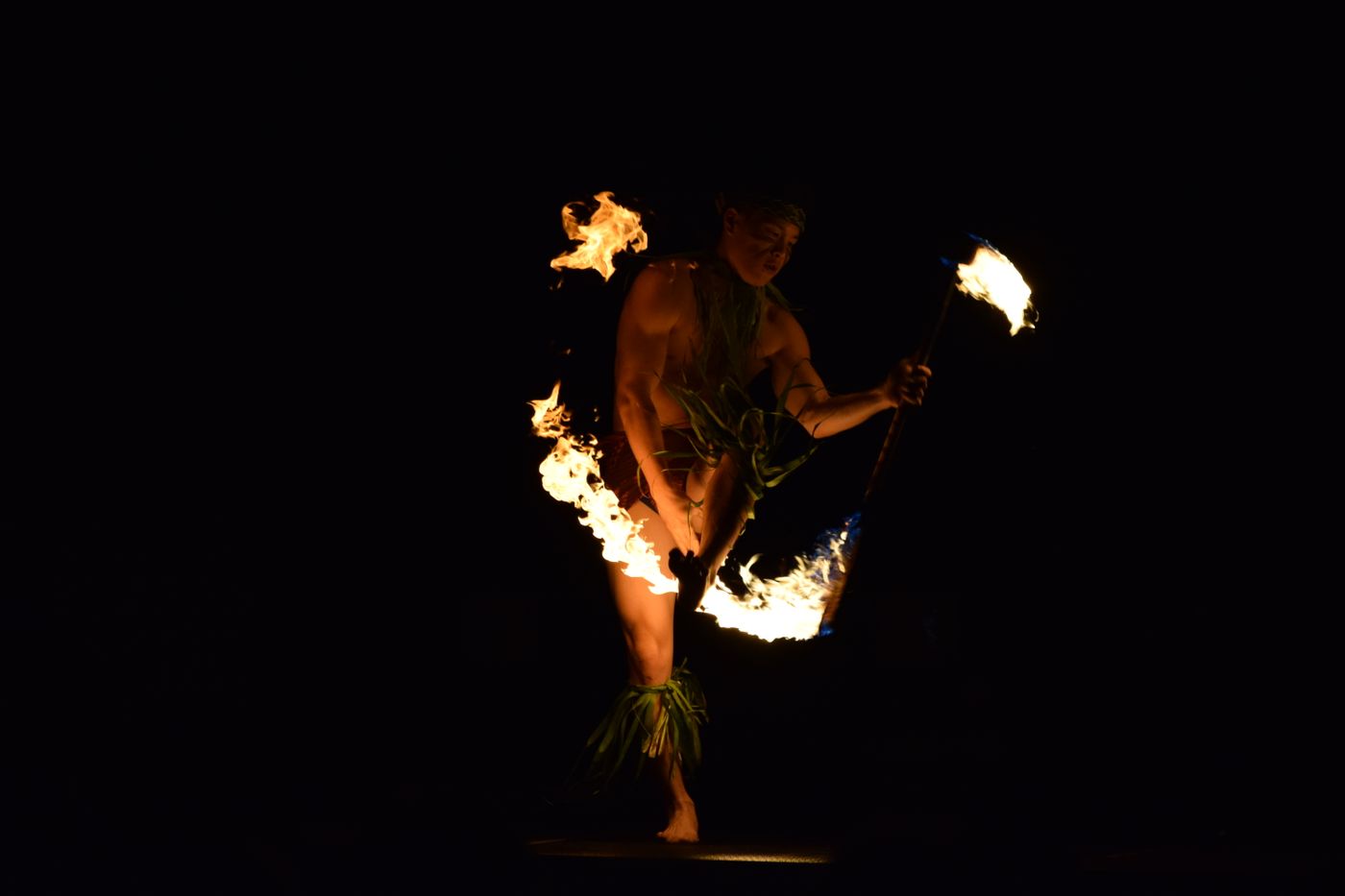 A fire dancer performing at night in Hawaii