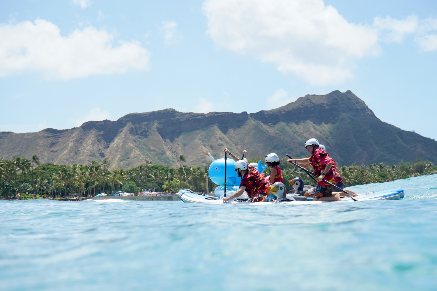 Paddlers exploring clear blue coastal water together